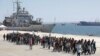 Migrants are disembarked from the Italian navy ship Vega in the Sicilian harbor of Augusta, southern Italy, May 4, 2015.