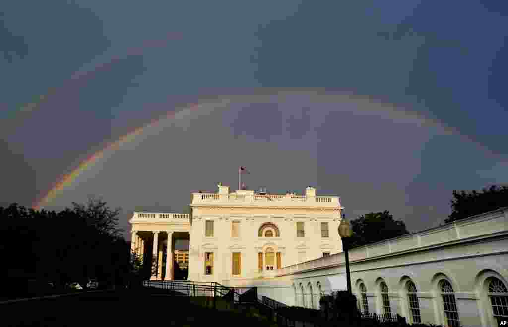 A double rainbow is seen over the White House during a rainstorm in Washington, DC.