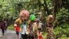 Internally displaced Congolese carry their belongings as they flee to safety, fearing renewed clashes between government forces and rebels in eastern Democratic Republic of Congo, May 21, 2012.
