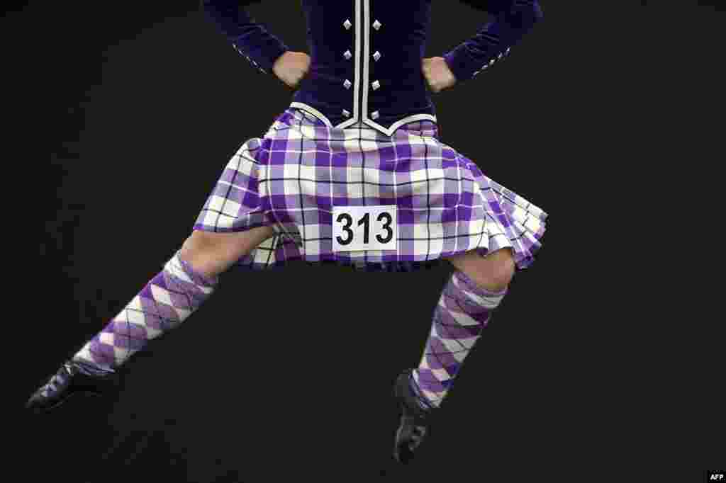 A competitor takes part in a Highland Country Dancing competition on Glasgow Green as part of the World Pipe Band Championships in Glasgow, Scotland, United Kingdom, Aug. 12, 2017.