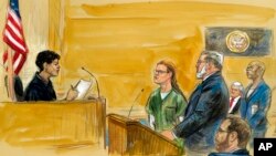 FILE - In a courtroom sketch, Maria Butina (C) is shown next to her attorney Robert Driscoll, before U.S. District Judge Tanya Chutkan, during a court hearing at the U.S. District Court in Washington, Dec. 13, 2018. 