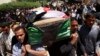 Residents carry a coffin during the funeral of an Iraqi soldier in Baghdad, April 25, 2013.