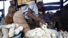 FILE - Women work in a cassava grinding mill in Nigeria, Nov. 19, 2009. Nigeria, an example of success for other African countries, produces about 20 percent of the world's cassava.