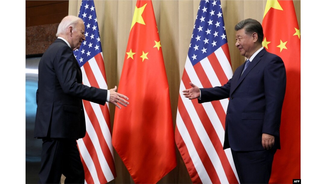 FILE - U.S. President Joe Biden shakes hands with Chinese President Xi Jinping on the sidelines of the Asia-Pacific Economic Cooperation summit in Lima, Peru, Nov. 16, 2024. (Pool/AFP)