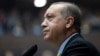 Turkey's President Recep Tayyip Erdogan looks toward cheering supporters as he addresses the members of his ruling party at the parliament in Ankara, Oct. 3, 2017. 