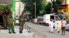 FILE - Members of the General Service Unit (GSU) stand guard along a street after assailants killed Muslim cleric Sheikh Mohammed Idris, chairman of the Council of Imams and Preachers of Kenya (CIPK), in the coastal port town of Mombasa, June 10, 2014. 