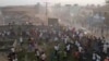 People scramble in Nzerekore, Guinea, where local officials said a deadly stampede ensued at a stadium following fan clashes during a soccer match, December 1, 2024, in this still image obtained from a social media video. (Social media via REUTERS)