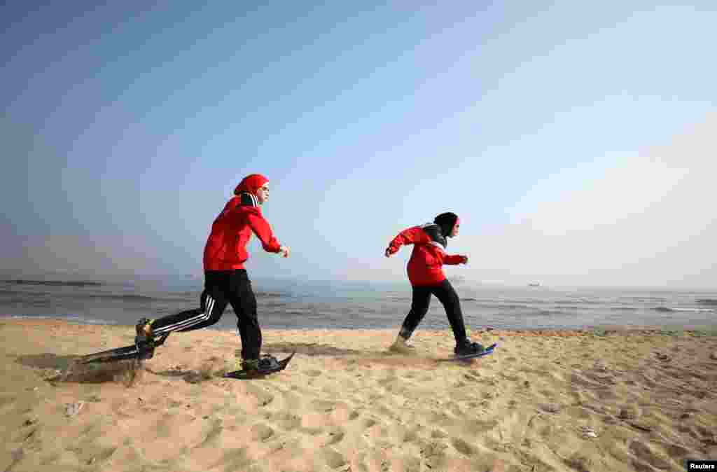 Special olympics athletes Esraa Gamal and Alaa Abdelaziz train with snowshoes on a beach in Alexandria, Egypt.