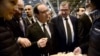 France's President Francois Hollande, center, samples some cheese as he visits the Paris international agricultural fair, Feb. 21, 2015.