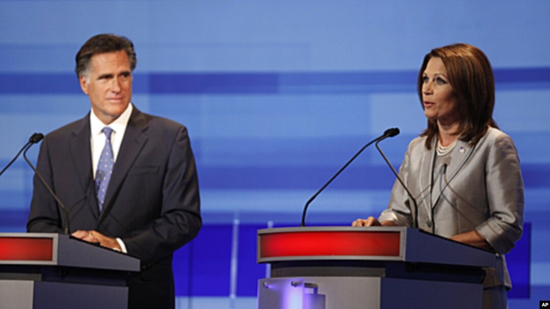 Republican presidential candidates former Massachusetts Gov. Mitt Romney listens to Rep. Michele Bachmann, R-Minn., during the Iowa GOP/Fox News Debate at the CY Stephens Auditorium in Ames, Iowa, Thursday, Aug. 11, 2011