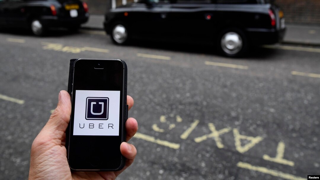 FILE - A photo illustration shows the Uber app logo displayed on a mobile telephone, as it is held up for a posed photograph in central London, Britain October 28, 2016.