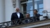 Iranian Foreign Minister Mohammad Javad Zarif (L) talks to journalist from a balcony of the Palais Coburg hotel where the Iran nuclear talks are being held in Vienna, Austria, July 9, 2015.