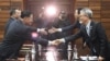 Kwon Hyok Bong, director of the Arts and Performance Bureau in North Korea's Culture Ministry, shakes hands with Lee Woo-sung, head of the South Korean delegation, after their meeting at Tongilgak, the North's building in the truce village of Panmunjom, North Korea, Jan. 15, 2018. 