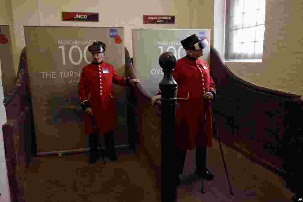 Chelsea pensioners John Kidman, 87, right, and Bill "Spud" Hunt, 83, wear virtual reality headsets during an exhibition at the Household Cavalry Museum in London.