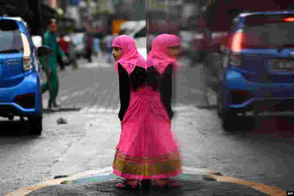 A Muslim girl leaves after Eid al-Fitr prayers in Kuala Lumpur, Malaysia.
