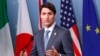 Canada's Prime Minister Justin Trudeau listens while addressing the final news conference of the G-7 summit in the Charlevoix city of La Malbaie, Quebec, June 9, 2018.