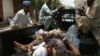 Pakistani villagers help victims from a blast to a district hospital in Landi Kotal Pakistan Afghanistan border, Saturday, June 16, 2012.