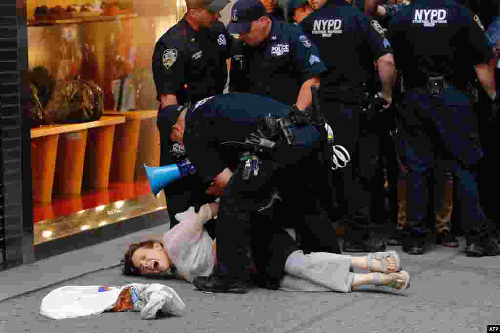 A woman is arrested by police near Trump Tower during a protest against U.S. President Donald Trump in New York, Aug. 14, 2017.