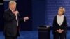 Republican presidential nominee Donald Trump speaks to Democratic presidential nominee Hillary Clinton during the second presidential debate at Washington University in St. Louis, Oct. 9, 2016.