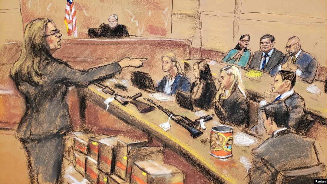 Assistant U.S. Attorney Andrea Goldbarg points at Mexican drug lord Joaquin "El Chapo" Guzman, back row center, in this courtroom sketch during Guzman's trial in Brooklyn federal court in New York City, Jan. 30, 2019. 