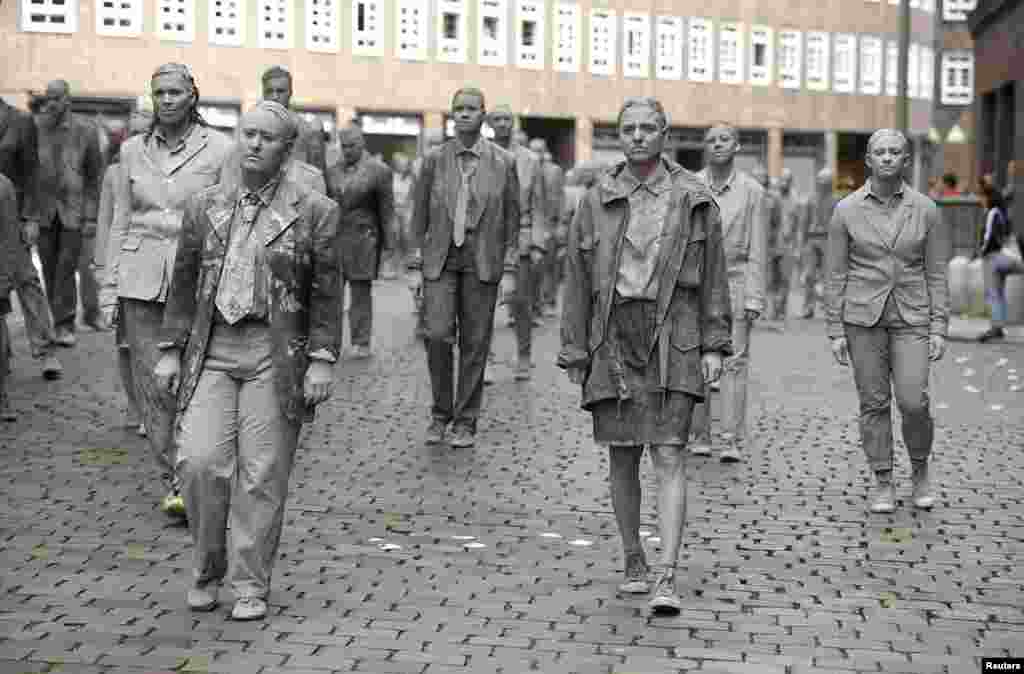 Participants perform during the so called "1000 Figures" demonstration before the upcoming G20 summit in Hamburg, Germany.