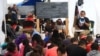 Volunteer teachers give class to children asylum seekers at a tent camp on the US border in Reynosa, Mexico. (Dylan Baddour/VOA)