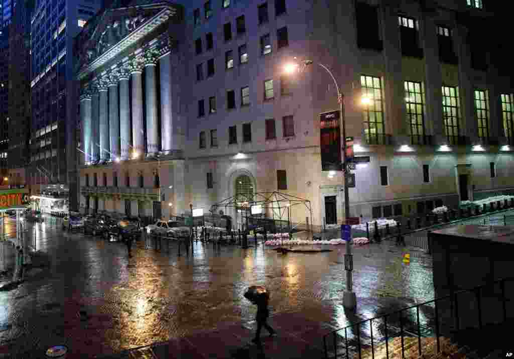 Sand bags protect the front of the New York Stock Exchange, October 29, 2012. Hurricane Sandy continued on its path Monday, forcing the shutdown of mass transit, schools and financial markets.