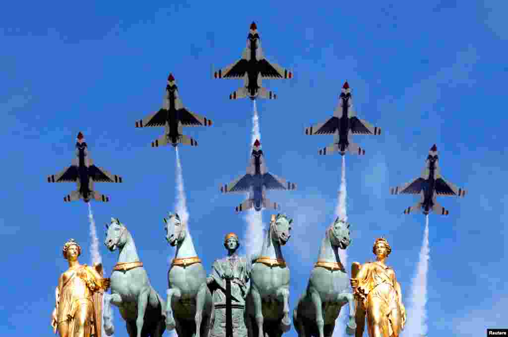 The U.S. Air Force Thunderbirds fly over the Arc de Triomphe du Carrousel during the traditional Bastille Day military parade in Paris, France.