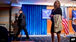 FILE - Secretary of State Mike Pompeo (L) and State Department spokeswoman Heather Nauert (R) depart a news conference at the State Department in Washington, Oct. 23, 2018.