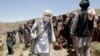 FILE - Members of a Taliban breakaway faction walk during a gathering, in Shindand district of Herat province, Afghanistan, May 27, 2016.