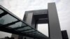 FILE - A policeman stands on a footbridge leading to the government headquarters complex in Hong Kong.