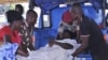 Rescue workers carry an injured person from a transport at St Gerard hospital in Kaduna, Nigeria, June 17, 2012. 
