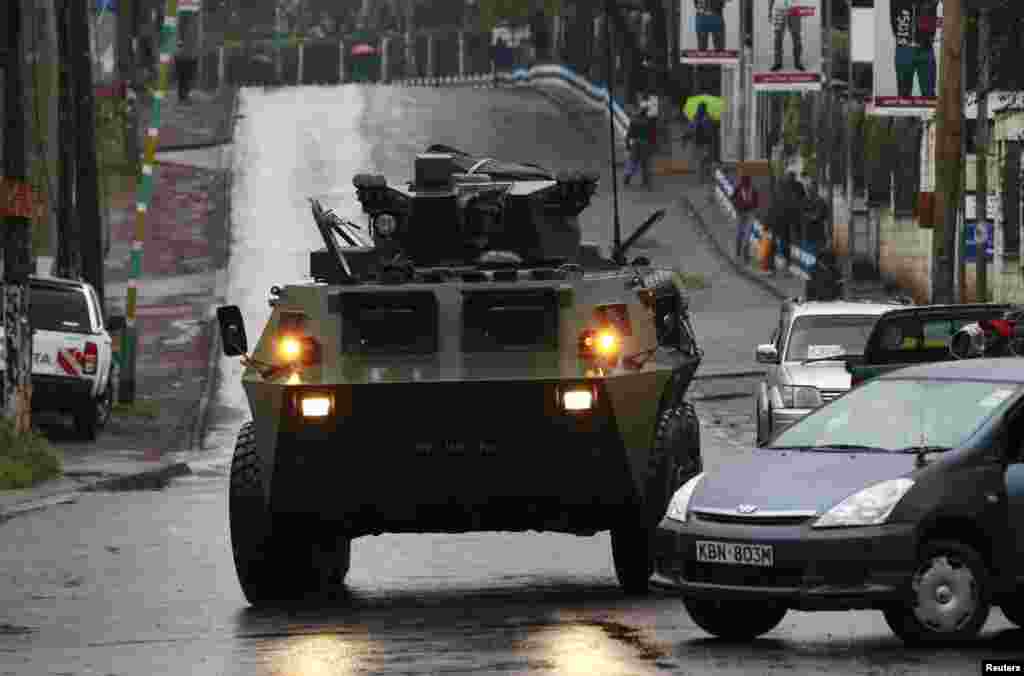 A Kenya Defense Forces armored military vehicle drives to the Westgate Mall after an exchange of gunfire inside the mall in Nairobi, Sept. 24, 2013.