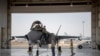 FILE - In this Aug. 5, 2019, photo released by the U.S. Air Force, an F-35 fighter jet pilot and crew prepare for a mission at Al-Dhafra Air Base in the United Arab Emirates.