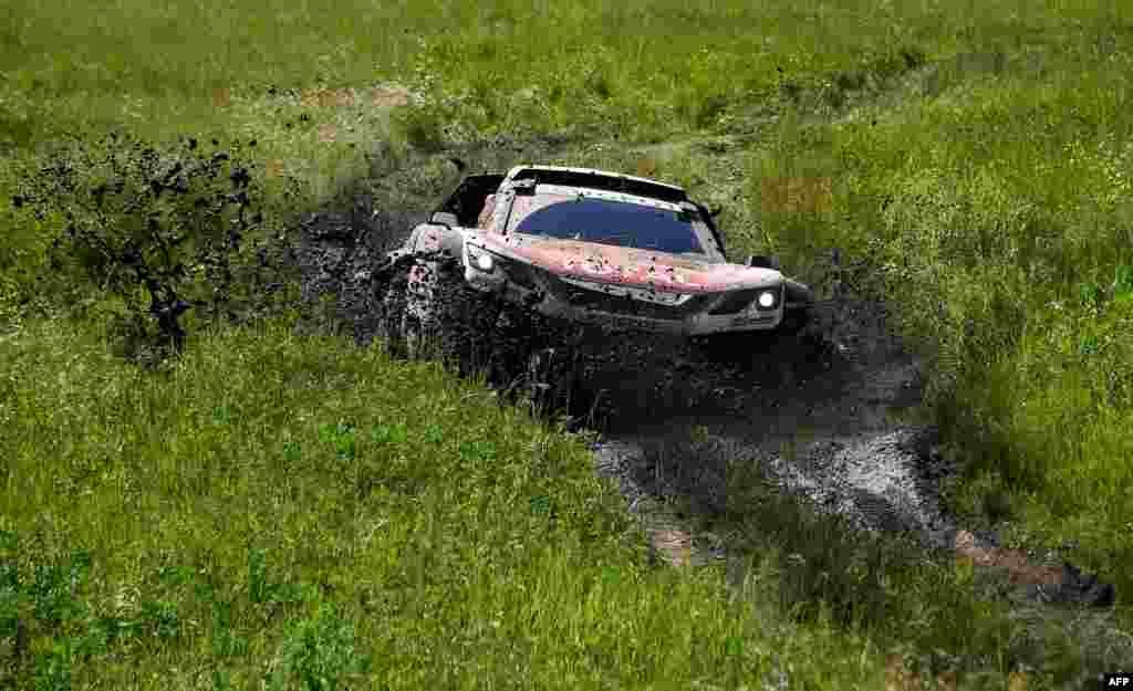 Peugeot's French driver Sebastien Loeb and French co-driver Daniel Elena compete during the Stage 3 of the Silk Way 2017 between Ufa and Kostanai, in Kazakhstan.
