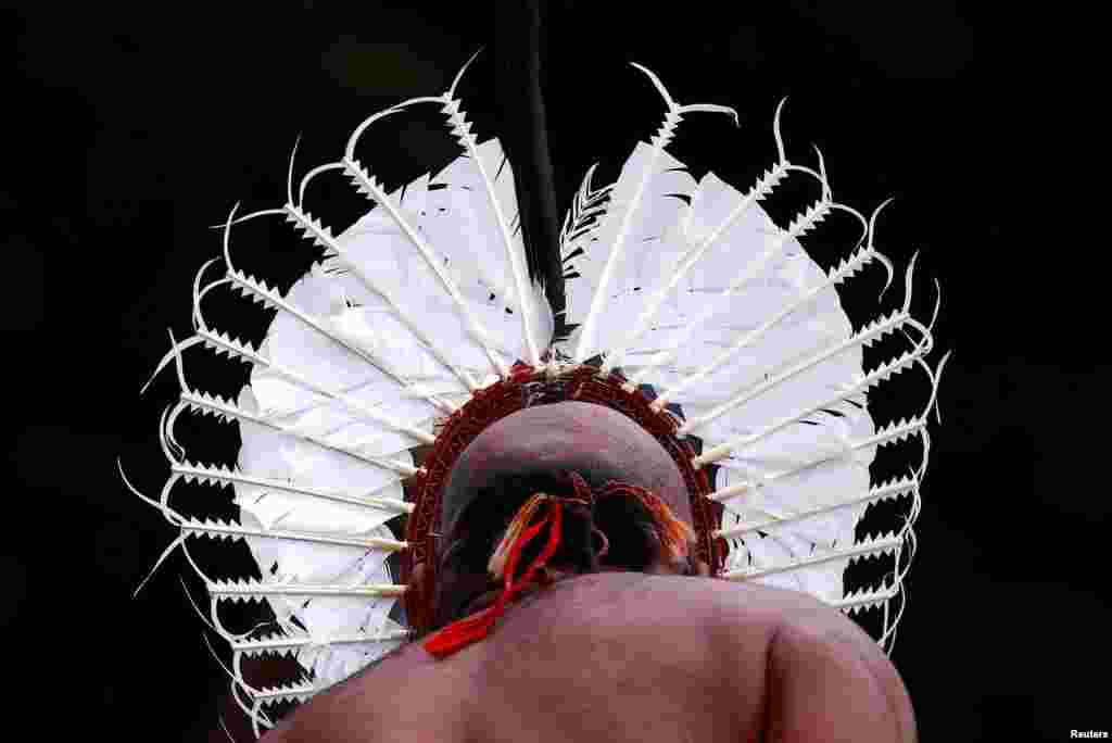 An indigenous man from the Torres Strait Islands wears a traditional dress as he performs during a welcoming ceremony at Government House in Sydney, Australia.