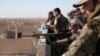 A Syrian Democratic Forces fighter looks through the scope of his weapon in Tal Samin village, north of Raqqa, Syria, Nov. 19, 2016.