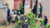 Foreign forensic experts, flanked by Kenyan military personnel, check the perimeter walls around Westgate shopping mall in Nairobi September 25, 2013. Bomb disposal experts and investigators searched through the wreckage of the Kenyan shopping mall on Wed