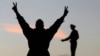 A supporter of the constitution gestures in front of a statue of Egypt's former Army Chief of Staff Abdel Moneim Riad near Tahrir square, during the final stage of a referendum on Egypt's new constitution in Cairo, Jan. 15, 2014. 