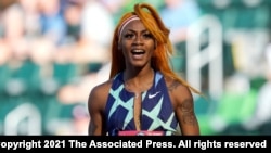 In this June 19, 2021, photo, Sha'Carri Richardson celebrates after winning the first heat of the semis finals in women's 100-meter run at the U.S. Olympic Track and Field Trials in Eugene, Ore.