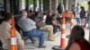 FILE - Job seekers exercise social distancing as they wait to be called into the Heartland Workforce Solutions office in Omaha, Nebraska, July 15, 2020.