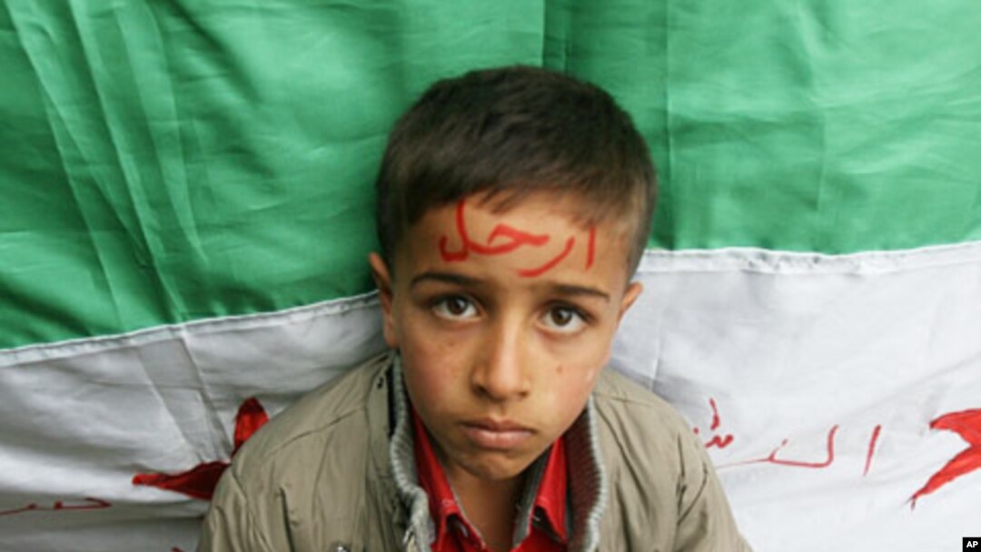 Syrian refugee with word 'Go' on his forehead, in reference to President Bashar al-Assad, northern Lebanon, Nov 12, 2011.