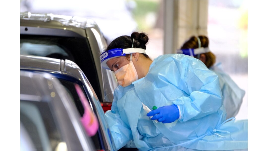A health worker administers a test for the coronavirus disease as the city experiences a new cluster of cases in Melbourne, Australia, May 25, 2021.