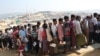 FILE - Rohingya refugees stand in a queue to collect aid supplies in Kutupalong refugee camp in Cox's Bazar, Bangladesh, Jan. 21, 2018.