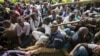 A Kenyan student is prodded in the head by a riot policeman's club inside Nairobi University's main campus in downtown Nairobi, May 20, 2014