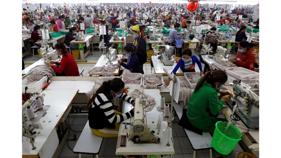 FILE - Employees work at a factory supplier of the H&M brand in Kandal province, Cambodia, Dec. 12, 2018.