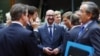 Belgian Prime Minister Charles Michel, center, stands among EU leaders at his first European Union summit in Brussels, Oct. 23, 2014. 