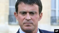 FILE - In this Oct. 23, 2013 file photo French Interior Minister, Manuel Valls pauses as he speaks to the media at the Elysee Palace in Paris.