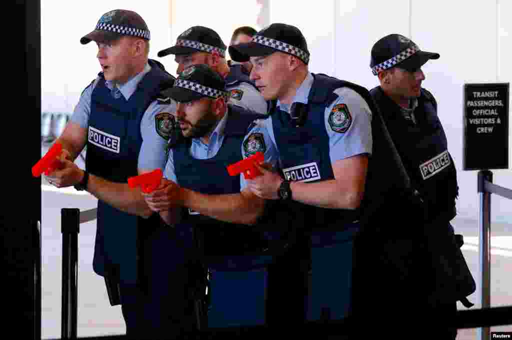 Australian police officers participate in a training scenario called an 'Armed Offender/Emergency Exercise' at an international passenger terminal at Sydney Harbor in Australia.