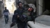 A man carries an injured boy in the rebel-held besieged town of Hamouriyeh, eastern Ghouta, near Damascus, Syria, Feb. 21, 2018.